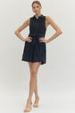 Solid sleeveless mini dress featuring floral lace overlay and self-tie belt at waist
