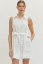 Solid sleeveless mini dress featuring floral lace overlay and self-tie belt at waist