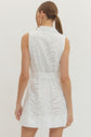 Solid sleeveless mini dress featuring floral lace overlay and self-tie belt at waist