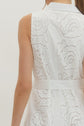 Solid sleeveless mini dress featuring floral lace overlay and self-tie belt at waist