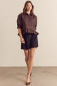 Solid Short Sleeve Button Down Top Featuring Ruffle Hem